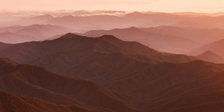 A landscape image of sunset over mountains used for our Honey Myrtle Essential Oil